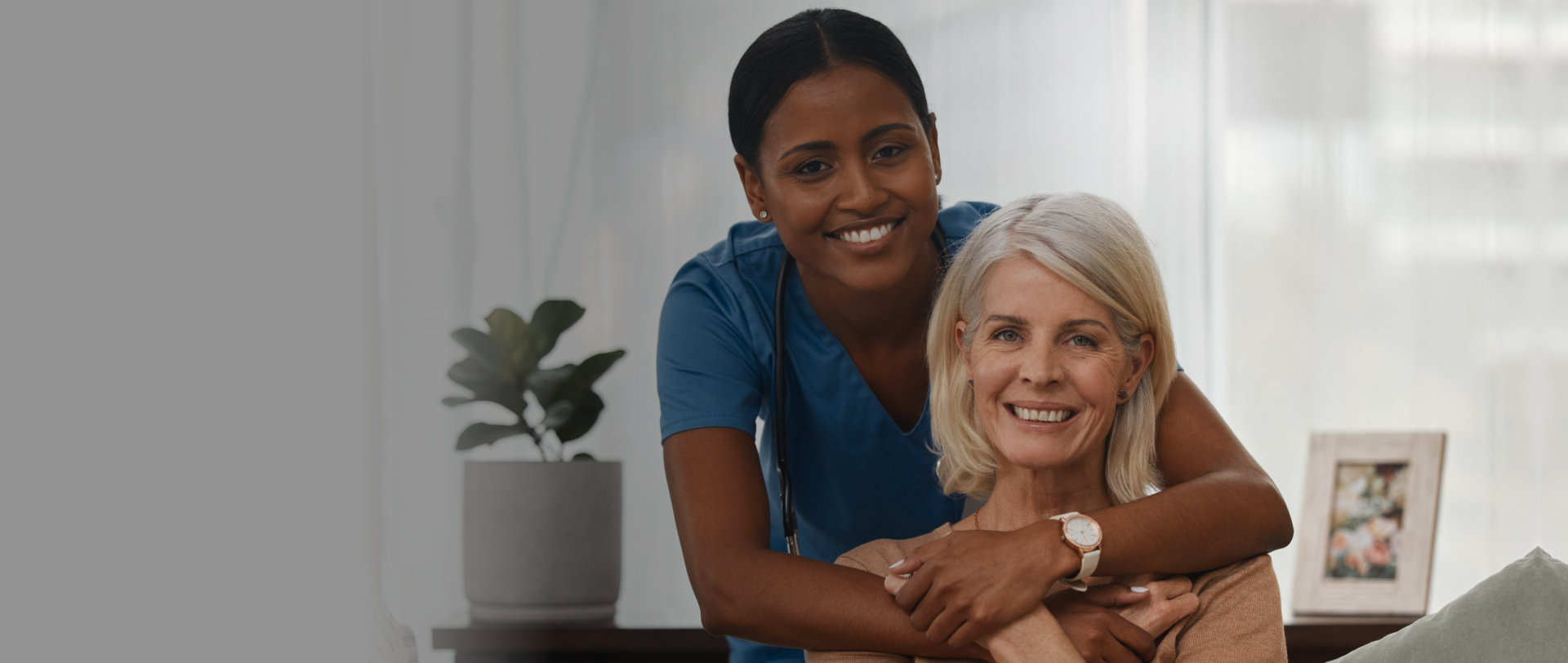 woman hug the elderly woman and smile