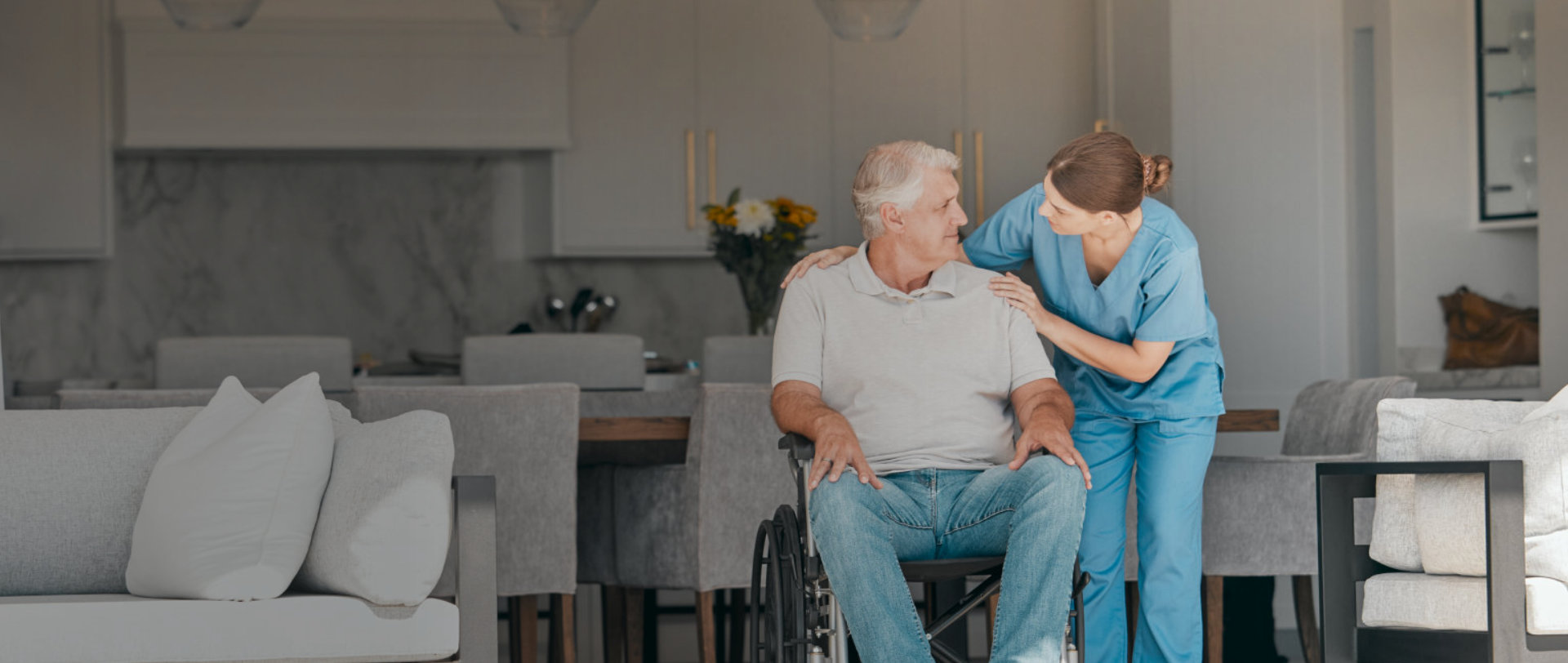 woman and elderly man in a wheel look each other