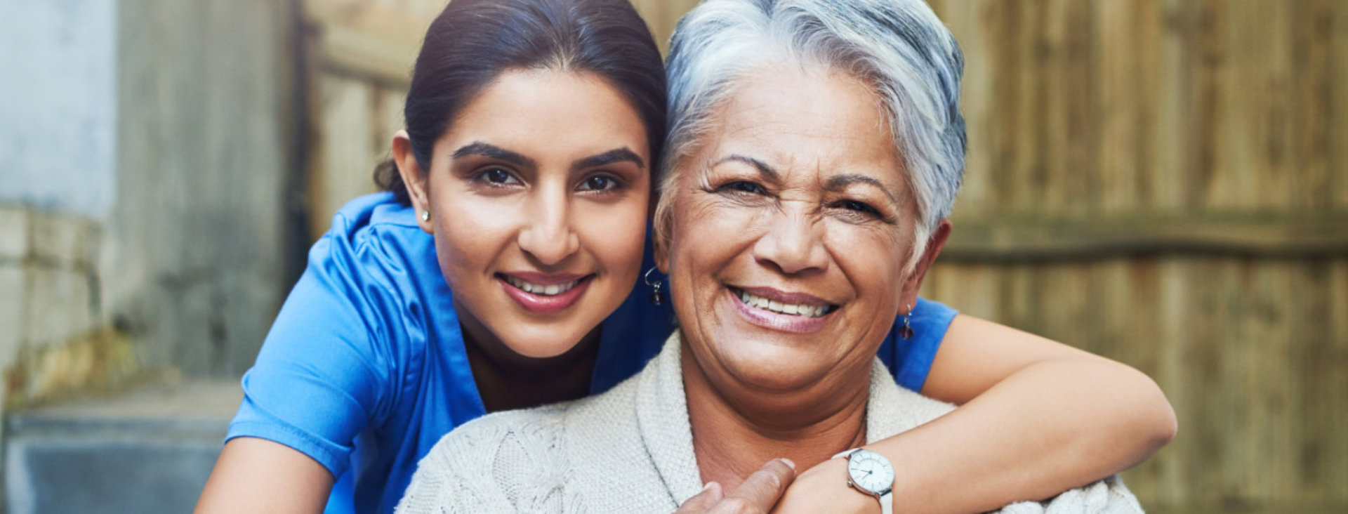 woman and elderly woman smiling.