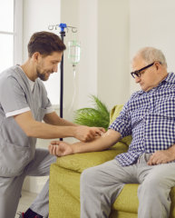 Caregiver assisting an elderly man