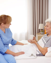 Caregiver assisting an elderly woman