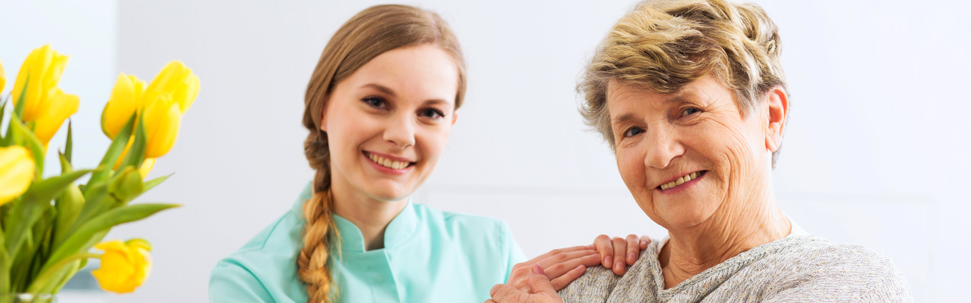woman and elderly woamn smiling.