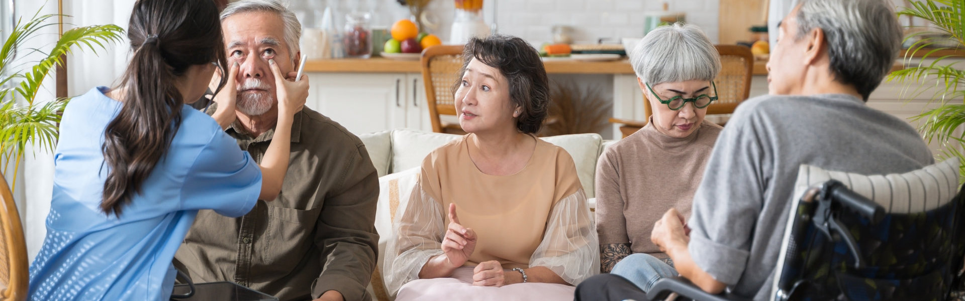 woman check the eyes of the elderly man