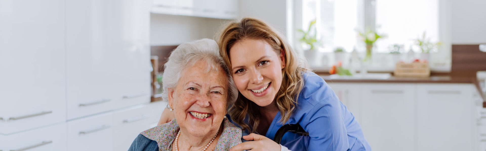 woman and elderly woman smiling.