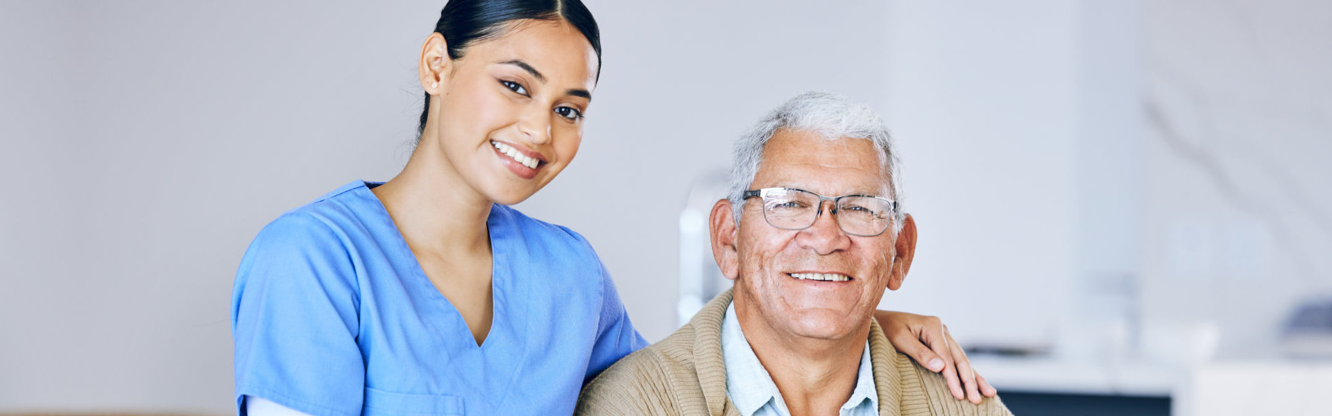 woman and elderly man smiling.