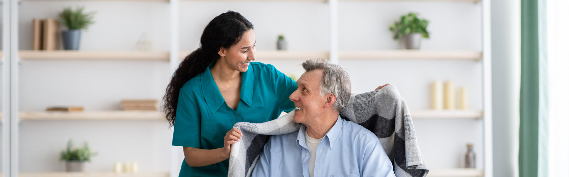 woman give towel to an elderly man.