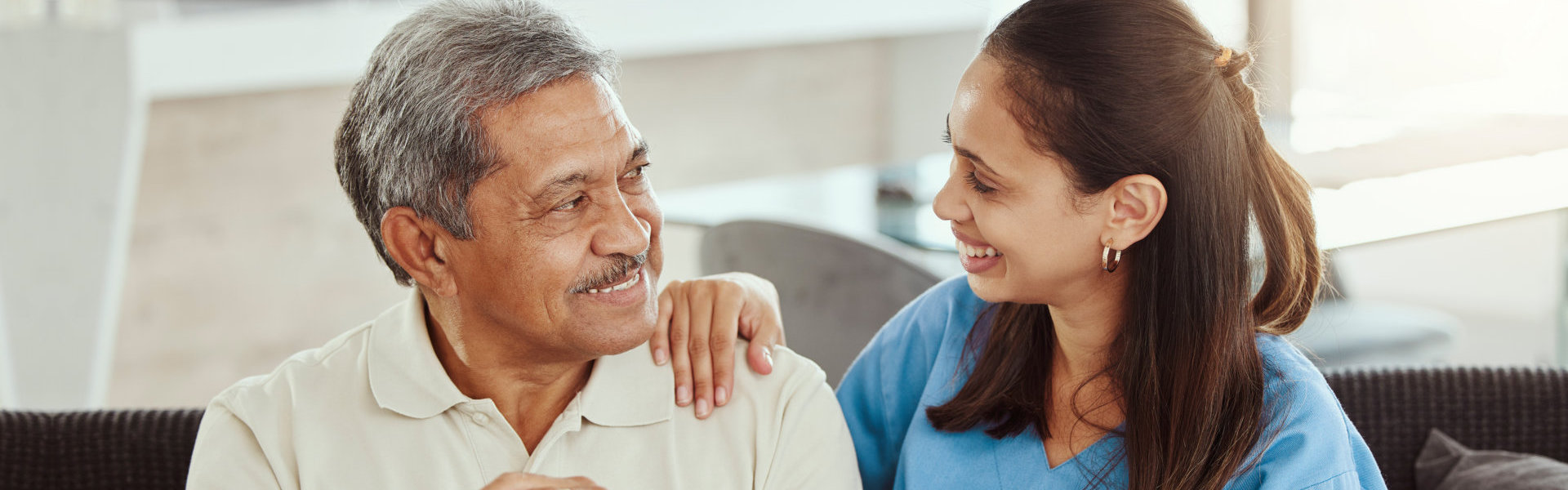 woman and elderly man smiling.